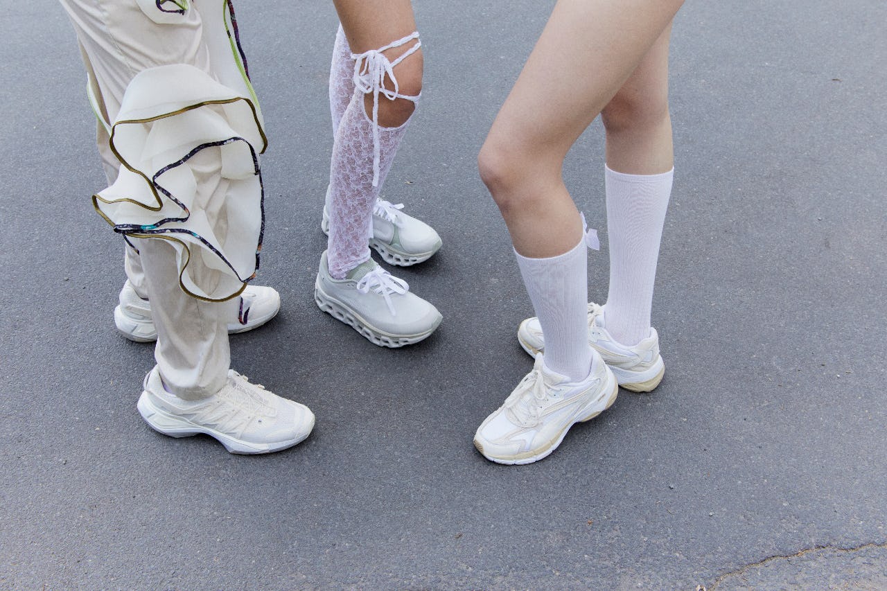 Close-up of three people in stylish, repurposed fashion, showcasing circular fashion through unique outfits and sneakers.